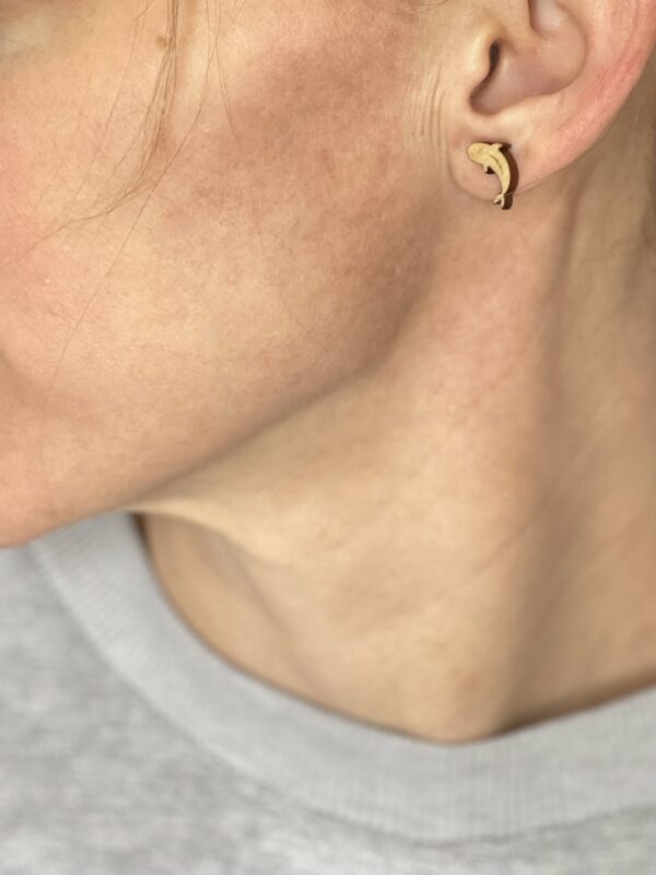 Wooden koi fish earring in ear