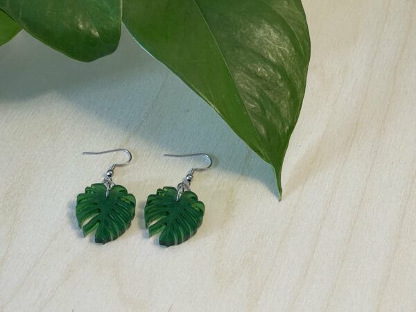 Acrylic monstera leaf dangle earrings in translucent green