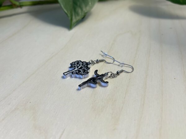 Acrylic yoga tree pose dangle earrings in two-tone black and white.