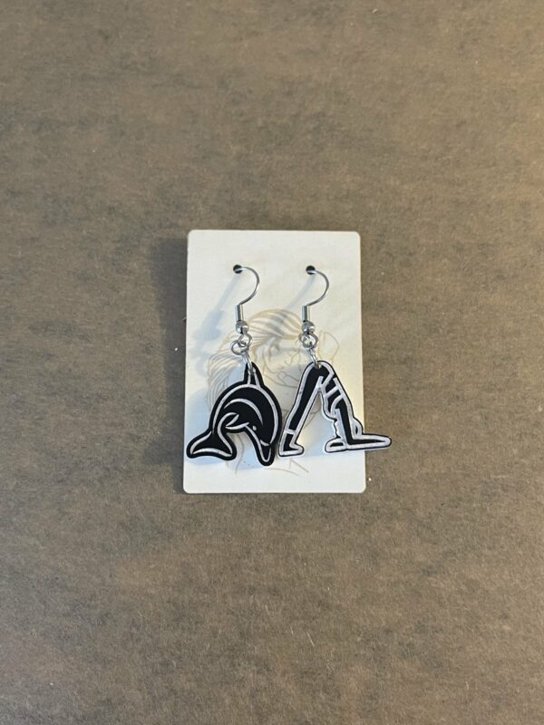 Acrylic yoga dolphin pose dangle earrings in black and white