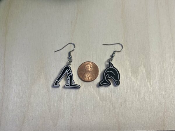 Acrylic yoga dolphin pose dangle earrings in black and white